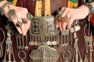 Traditional Armenian silver jewelry with ornate rings, belts, and charms showcasing cultural craftsmanship and heritage.