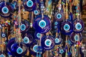 Blue evil eye charms and beaded talismans displayed together