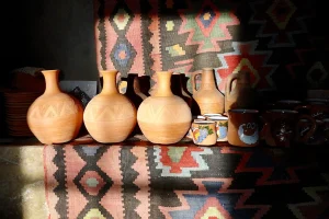 Handmade Armenian pottery displayed on a traditional rug
